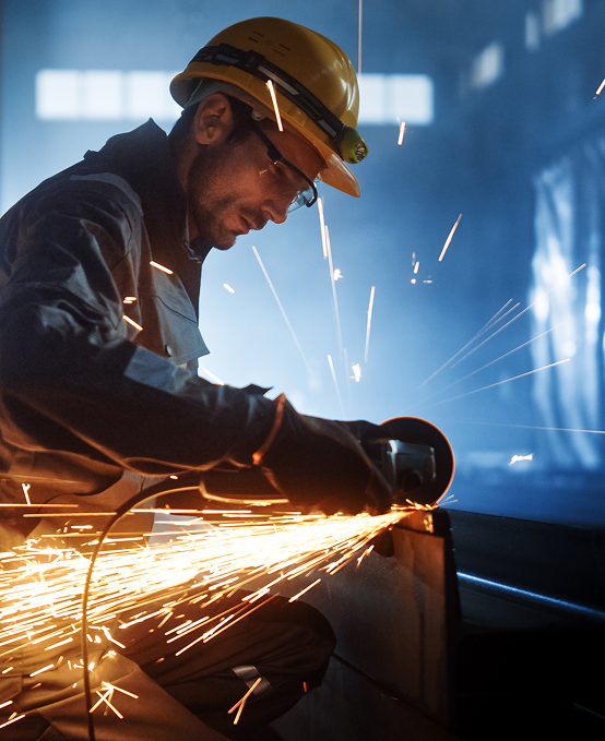 Factory worker using Metal Manufacturing ERP to monitor fabrication tasks and shop floor operations.